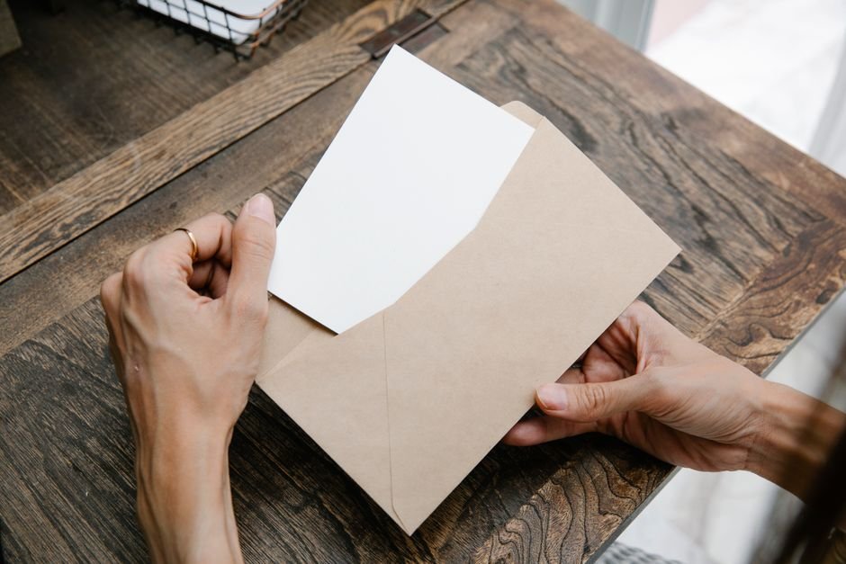 Person reading a letter at a table