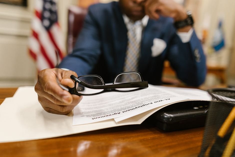 Policy documents and reading glasses on a desk